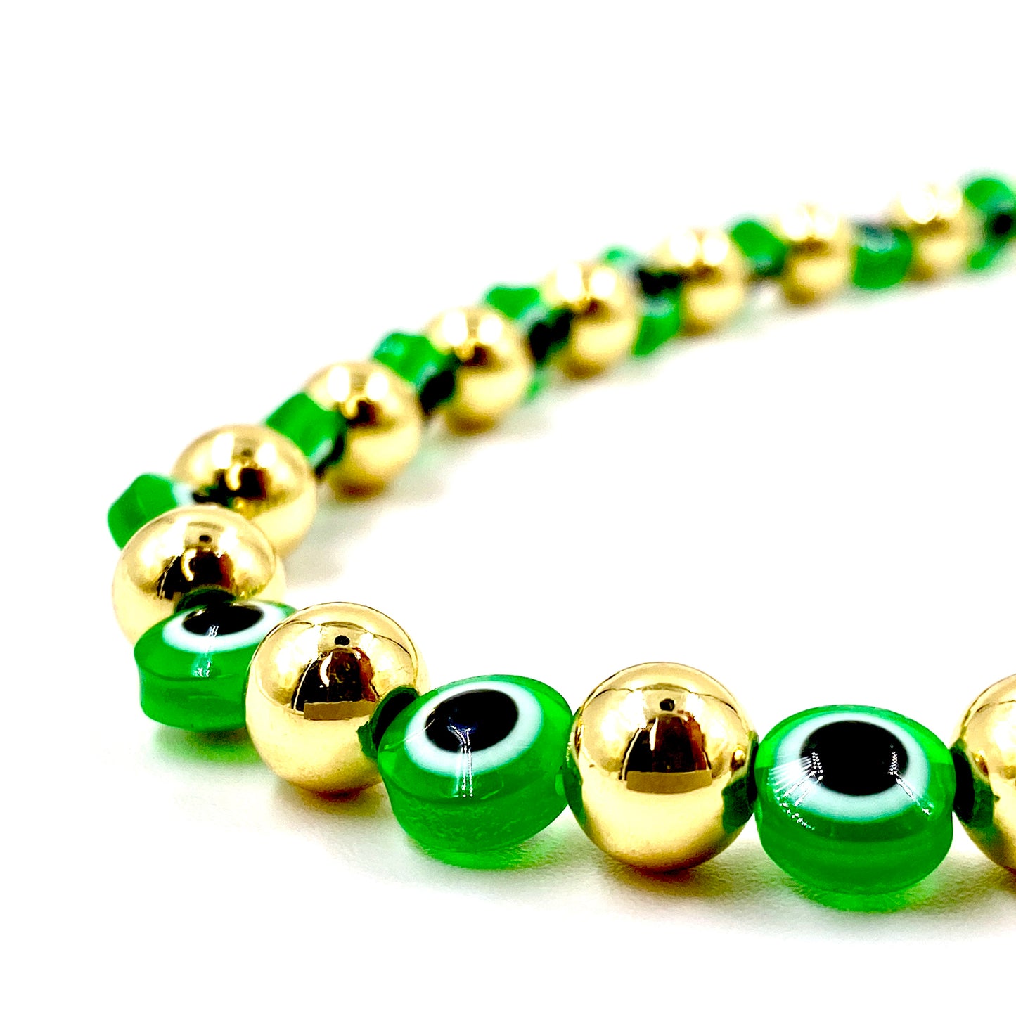 Collar con balines dorados y ojo turco verde