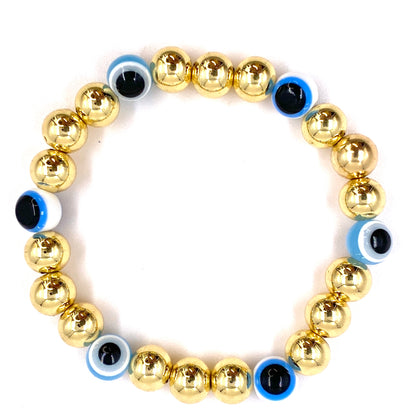 Pulsera con balines dorados grandes y ojo turco celeste