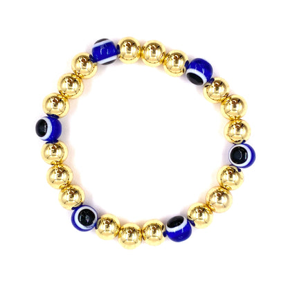 Pulsera con balines dorados grandes y ojo turco azul