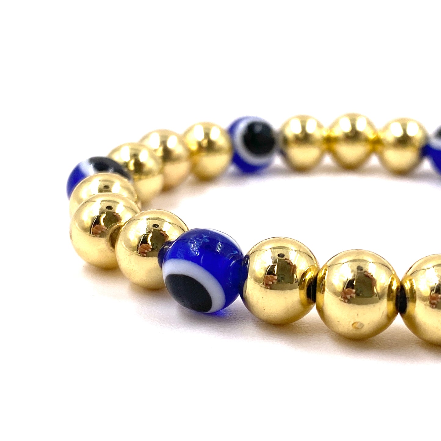 Pulsera con balines dorados grandes y ojo turco azul