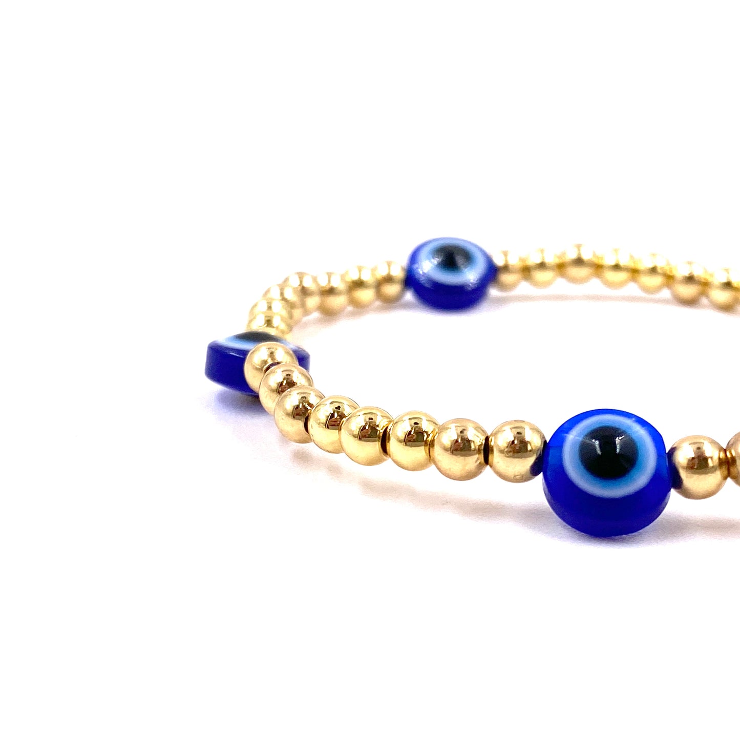 Pulsera con balines dorados pequeños y ojo turco azul