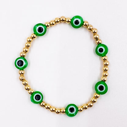 Pulsera con balines dorados pequeños y ojo turco verde